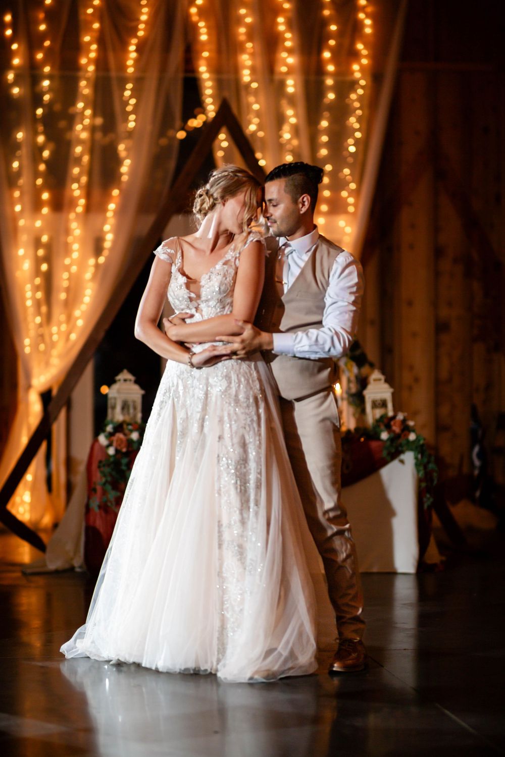 First dance of bride and groom with fairy lights backdrop at a Northwest Arkansas wedding, by Michele McCoy Photography.