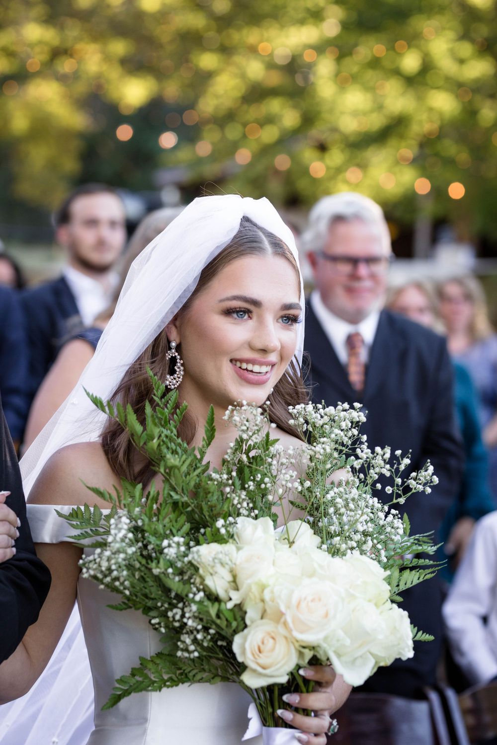 Bride with white rose bouquet at Eureka Springs wedding, captured by Michele McCoy Photography.