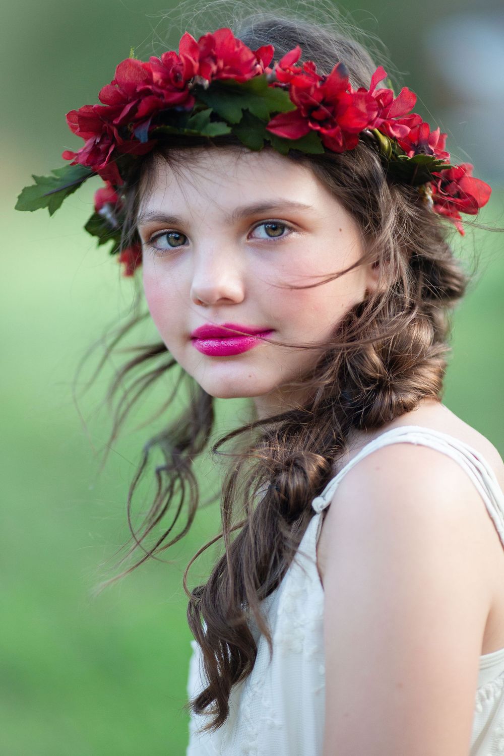 Young bridesmaid with red floral crown at Bluebird Estate in Mt Pleasant, AR, by Michele McCoy Photography.