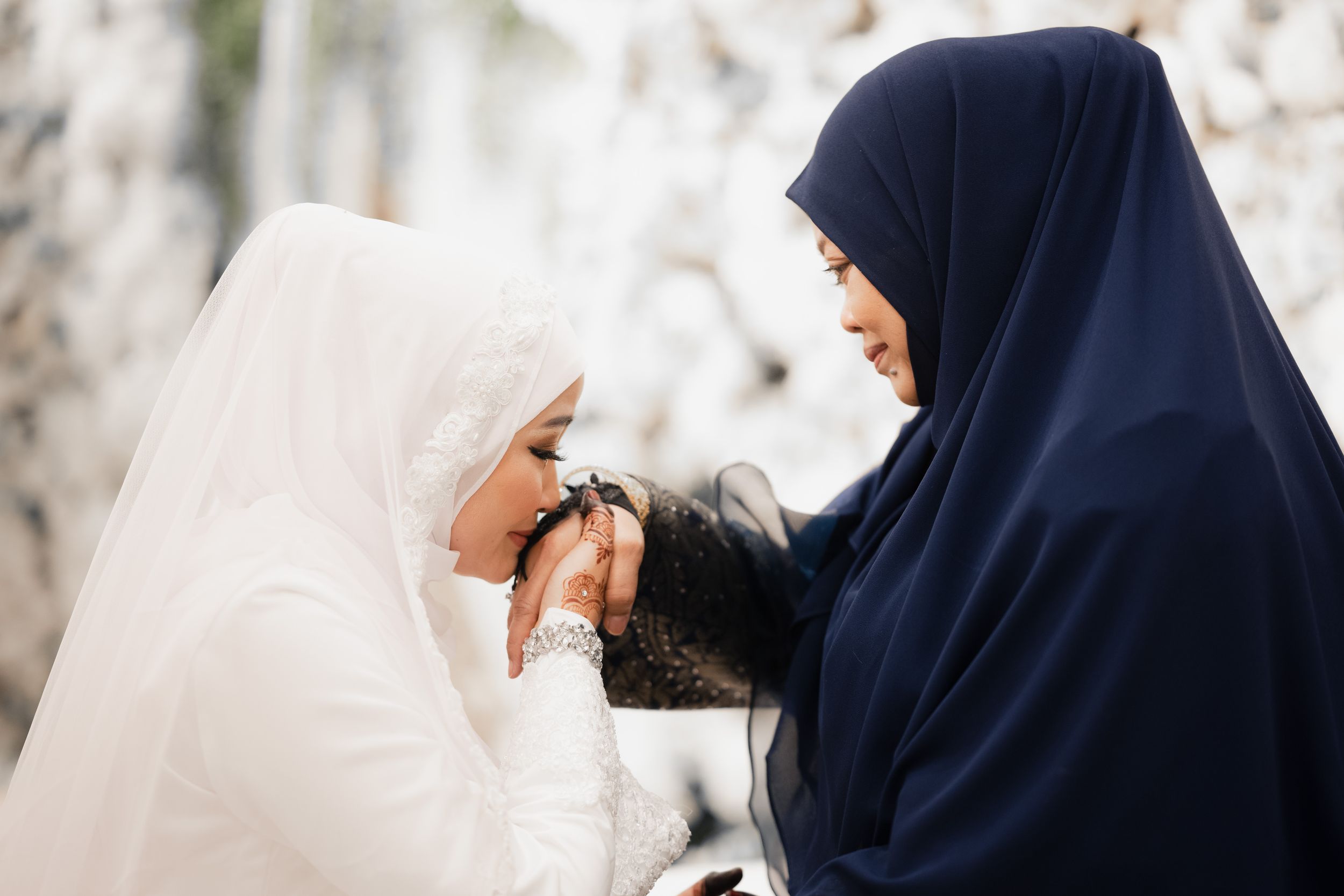 Bride performing salam to mother during her wedding day