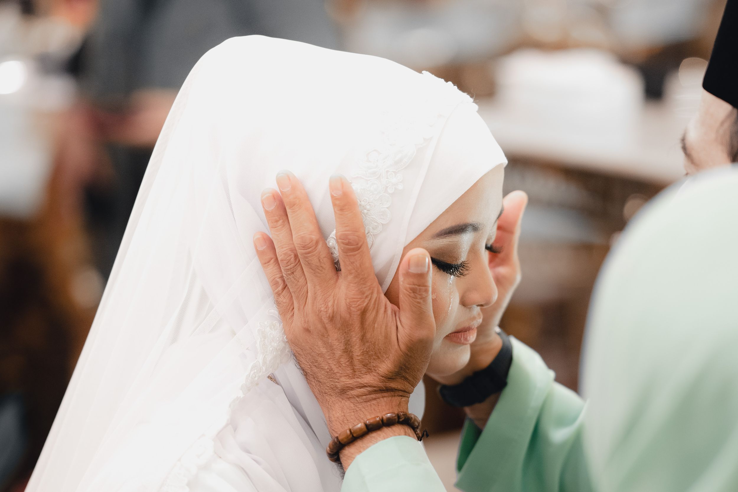 Emotional shot of bride crying infront of father