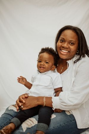 Studio portrait featuring matching white outfits against a light backdrop.