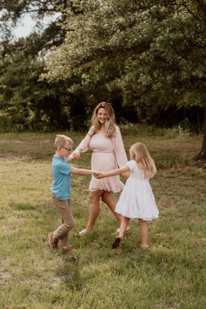 Dancing and playing together in a sunny field during golden hour.