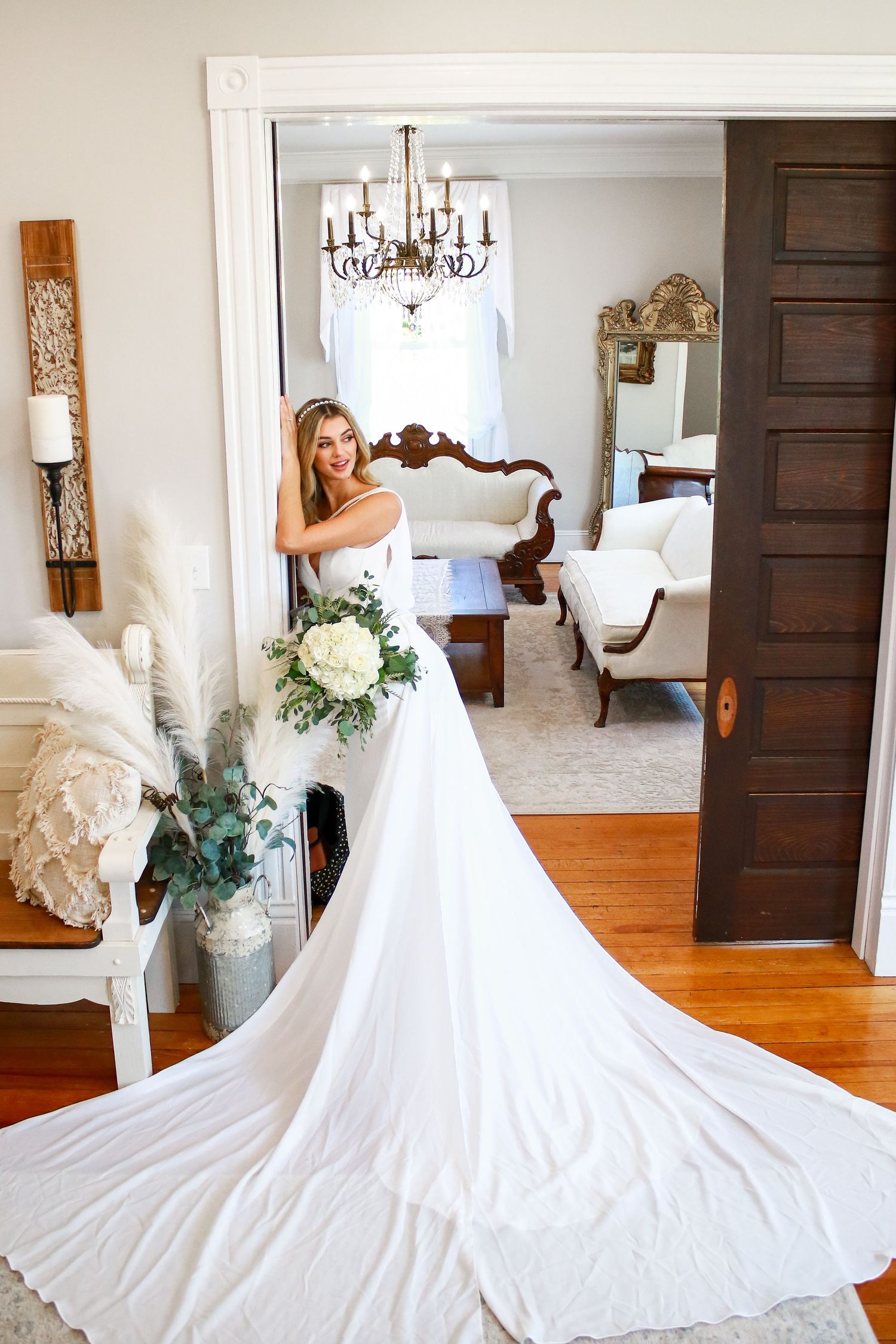 A bridal photo series featuring a flowing white wedding gown in an elegant indoor setting.