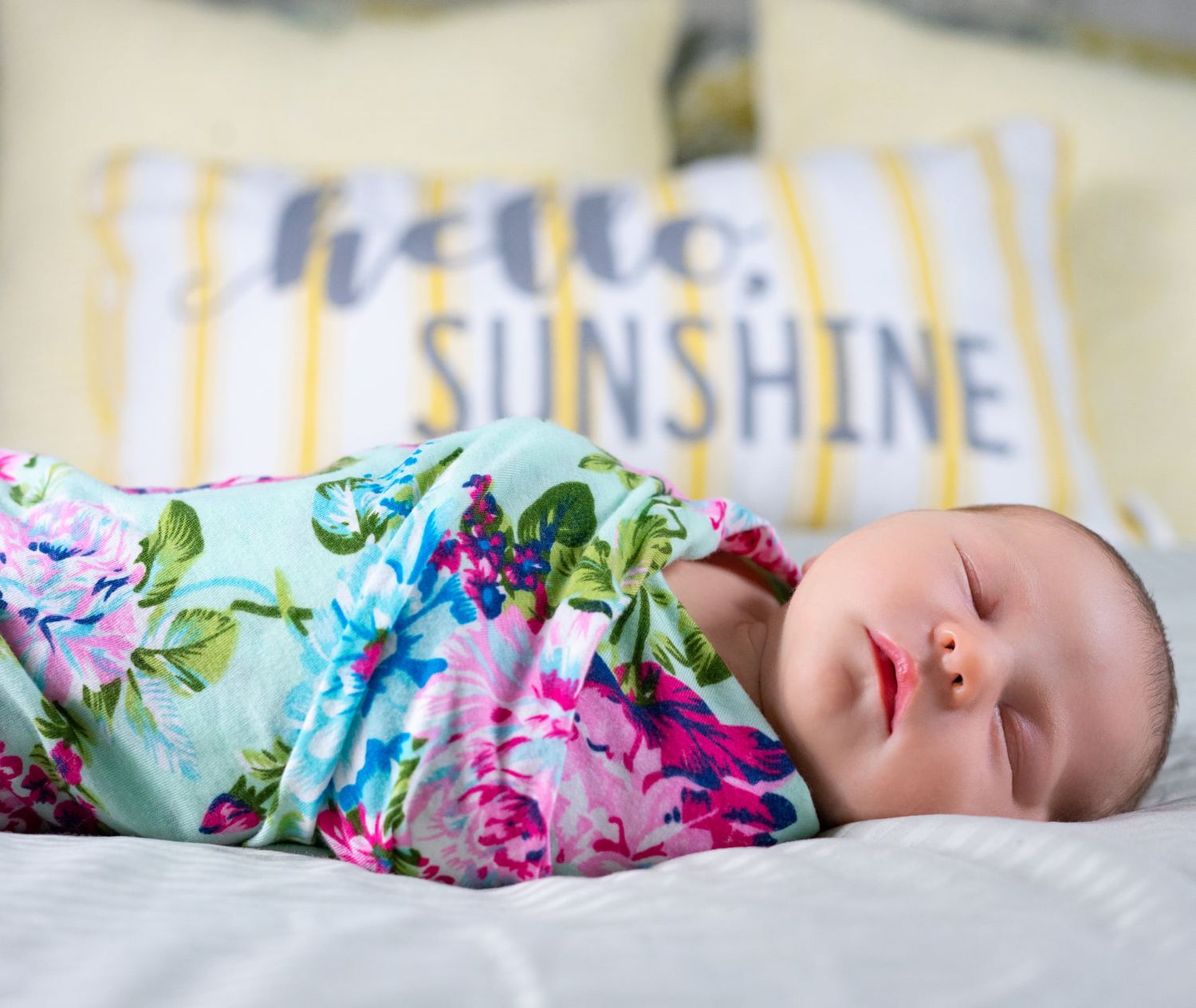 Newborn in home session in Tampa - baby swaddled on bed