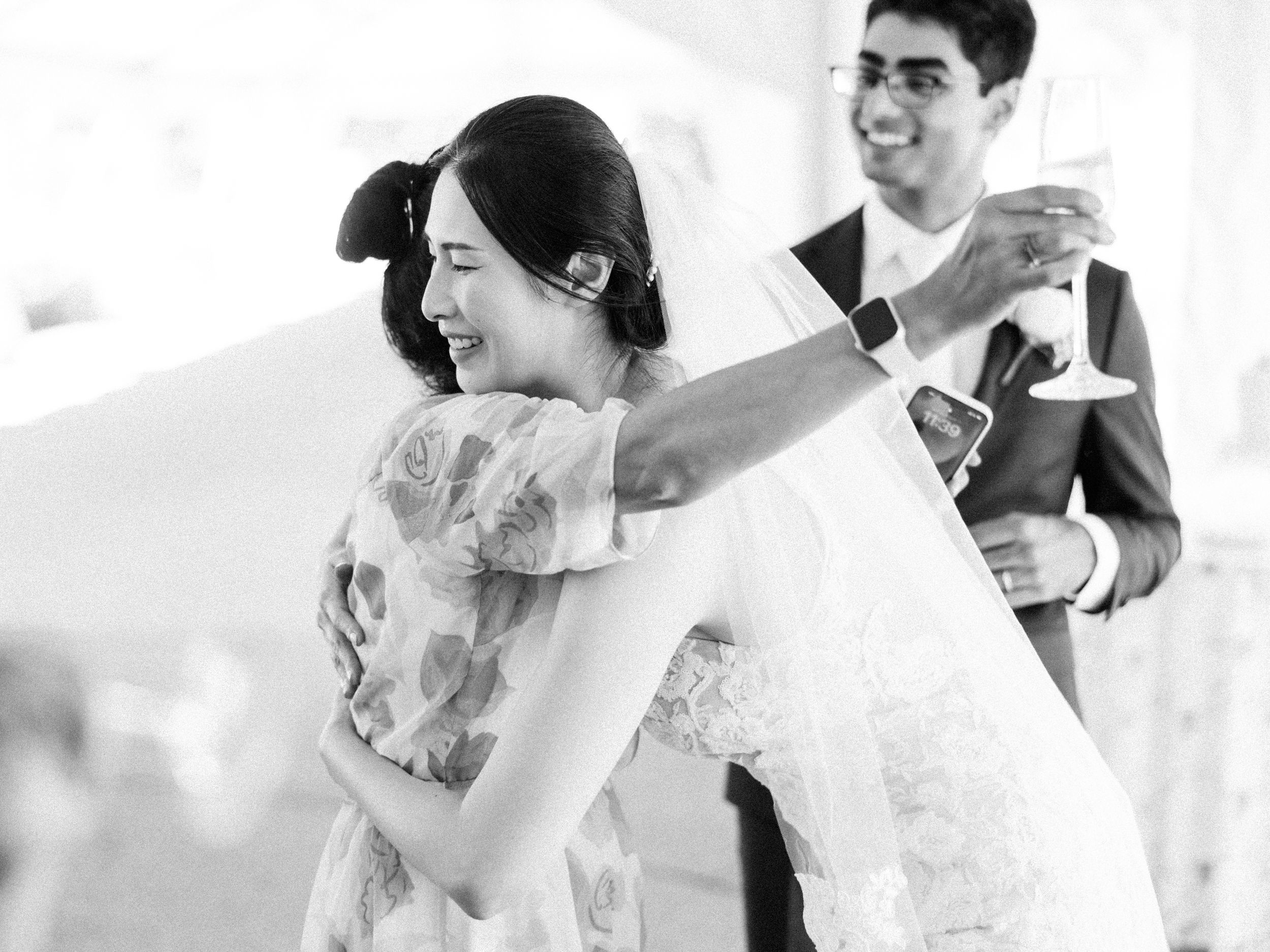Joyful celebration moments captured in black and white at wedding reception.