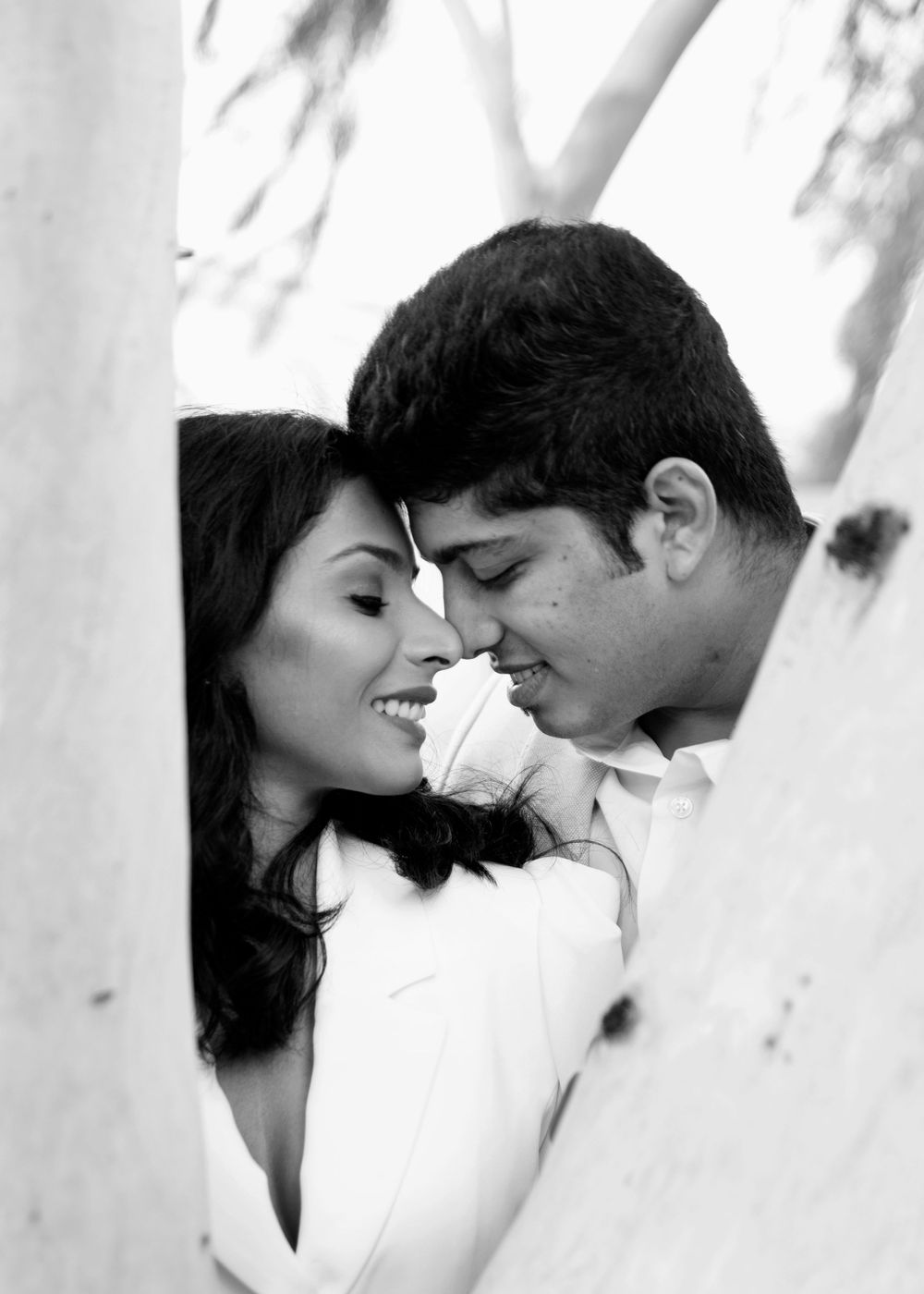 Black and white romantic portrait of a couple sharing an intimate moment.