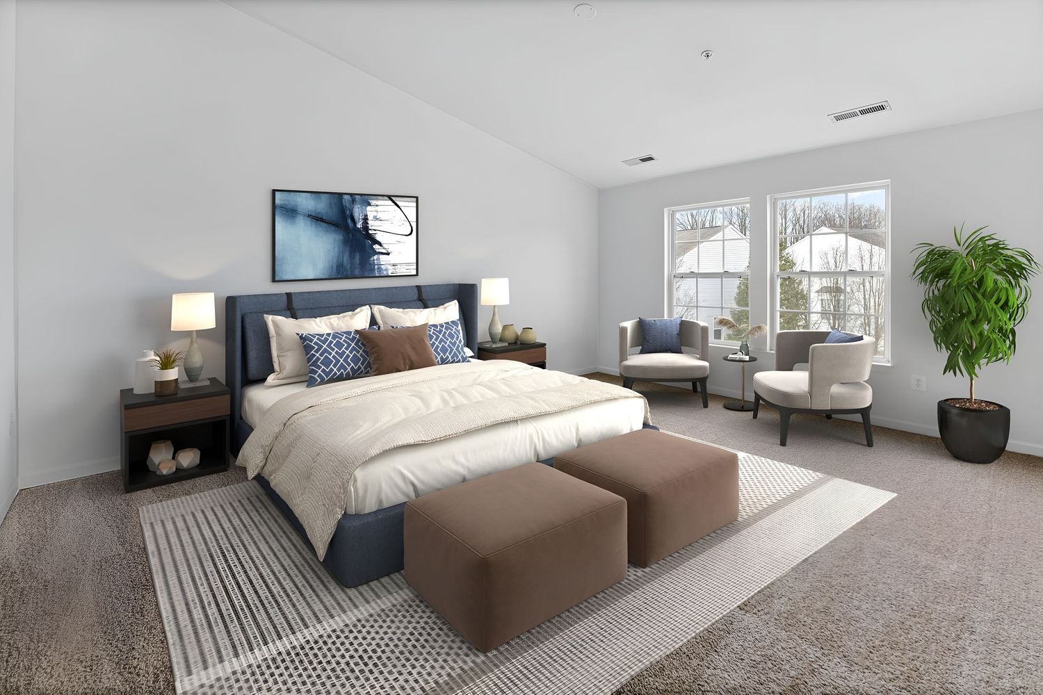 Open concept living space with neutral tones, modern seating and large windows providing natural light.