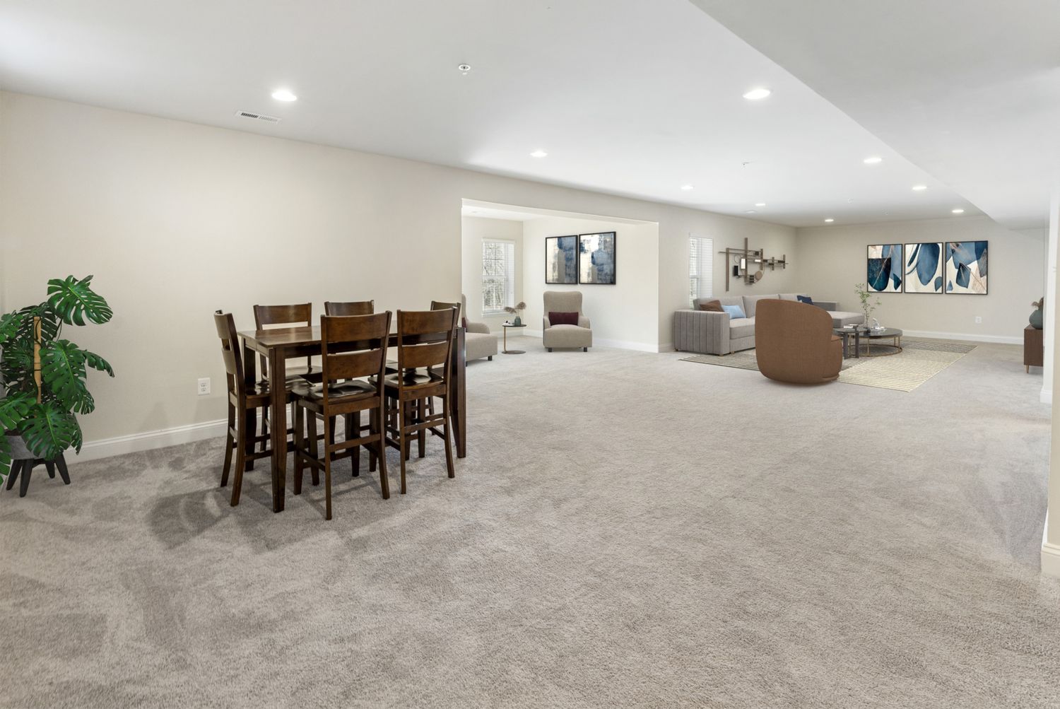 Large basement recreation room with carpeting and dining furniture visible in the background.