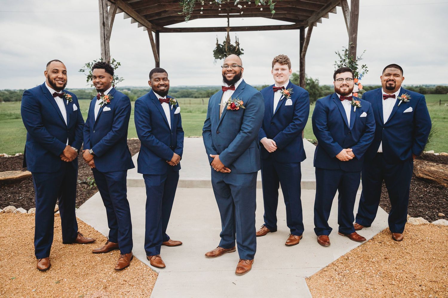 Groom posing with his groomsmen for a group shot at he Barn at Wolf Ridge Farm