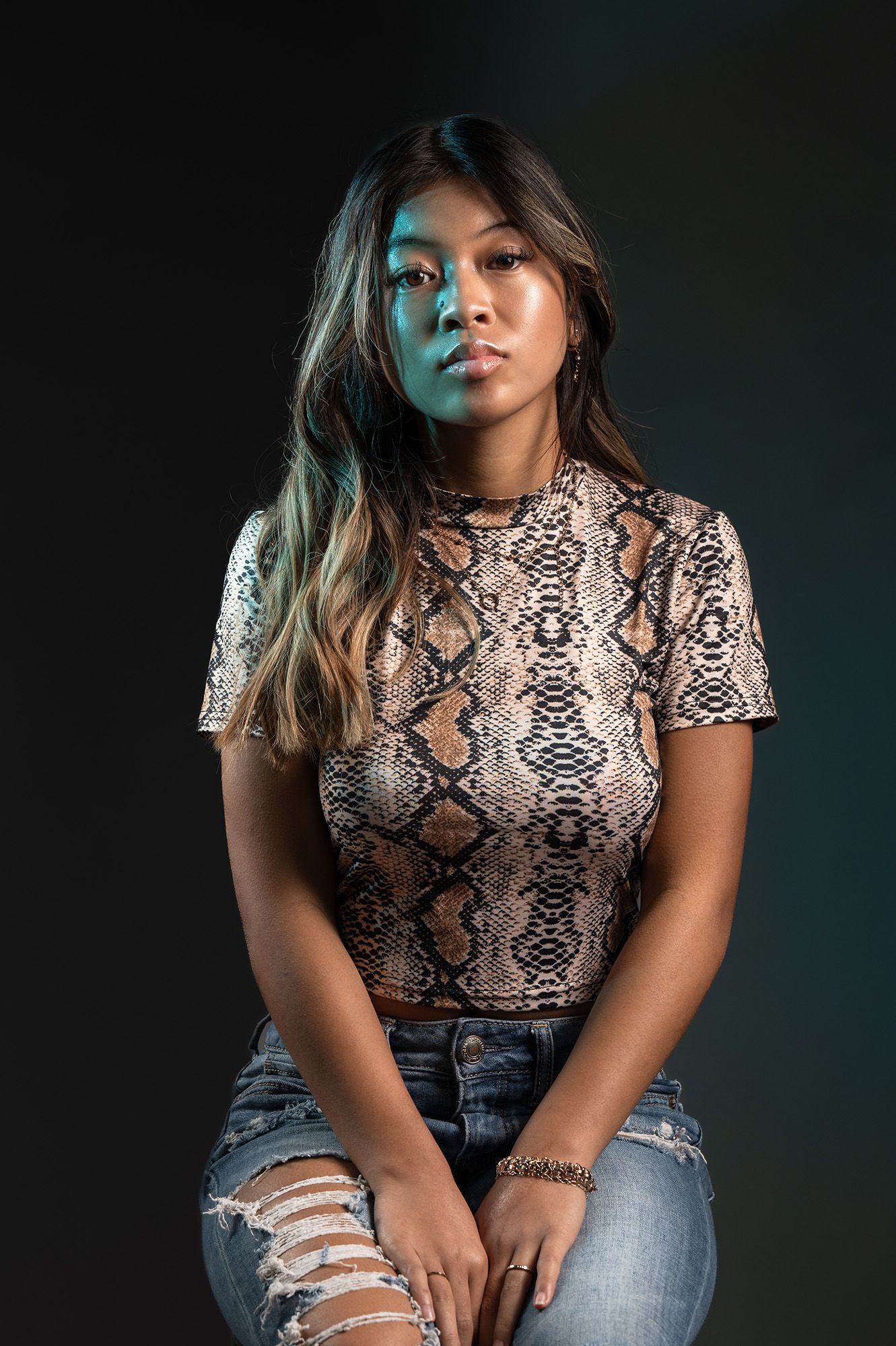 Studio portrait of a teenage girl, soft light and grey background.
