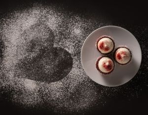 Product photography of Valentines Day Cupcakes with heart shaped image in powdered sugar.