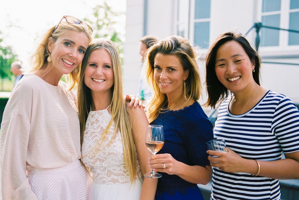 A group enjoying a celebration outdoors in summer attire.