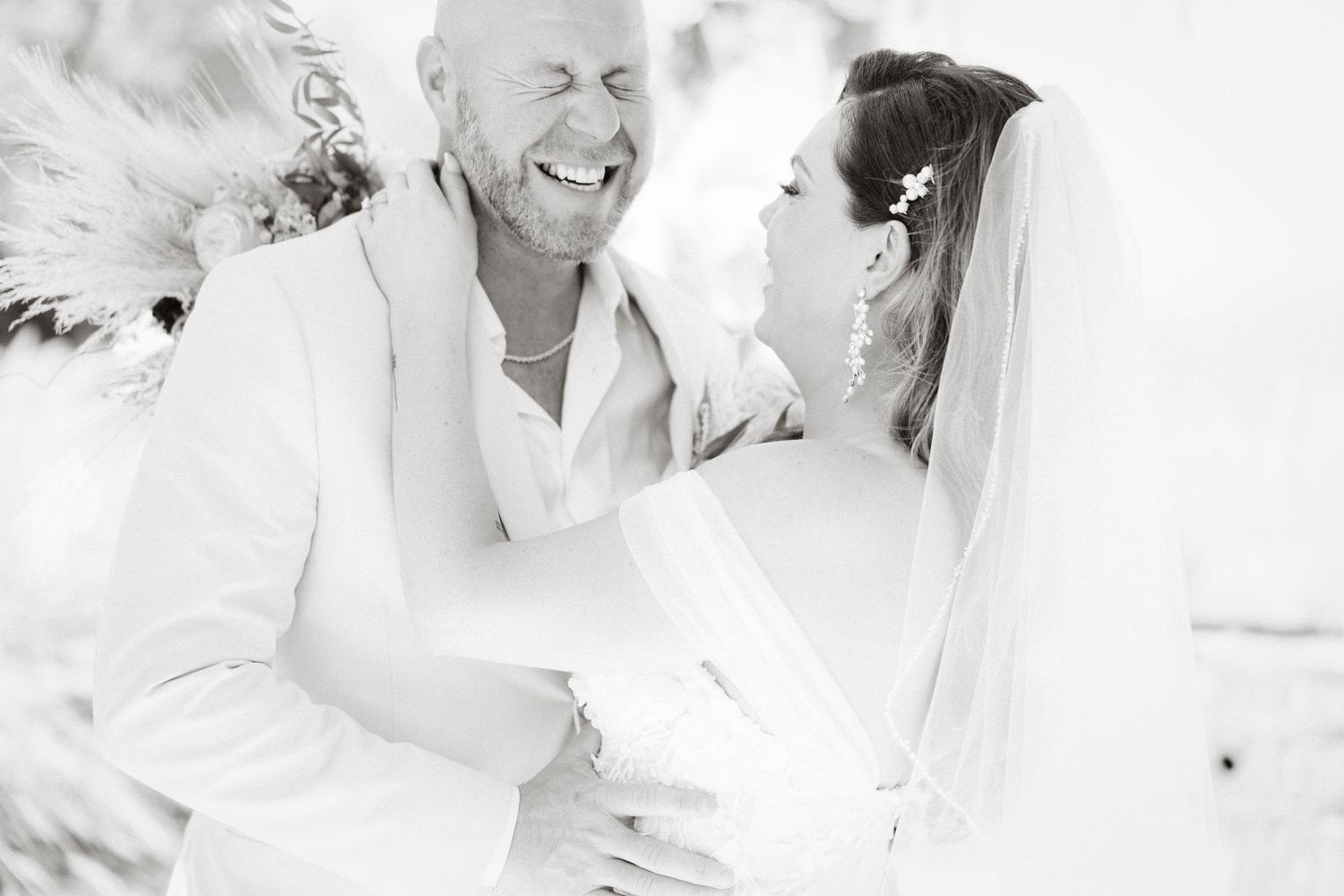 A bright and joyful black and white moment shared during wedding preparations.