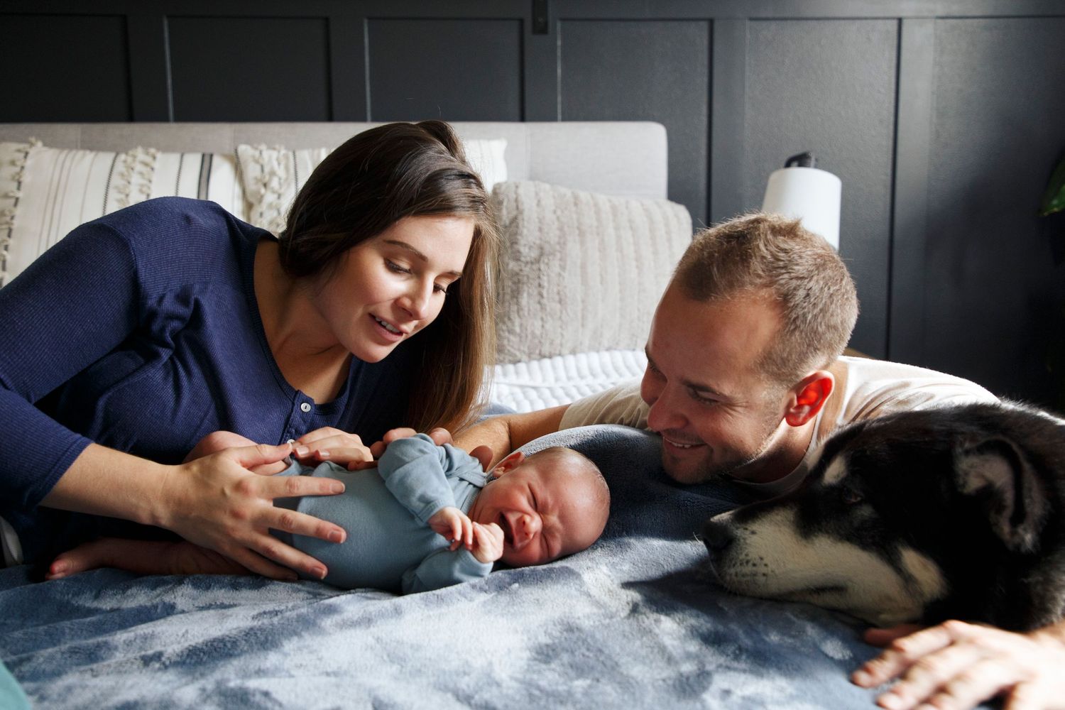 snohomish newborn photography: a newborn with his mother, father and dog at home in snohomish