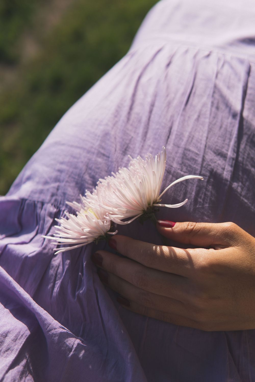 A pregnant woman's belly with a flower.