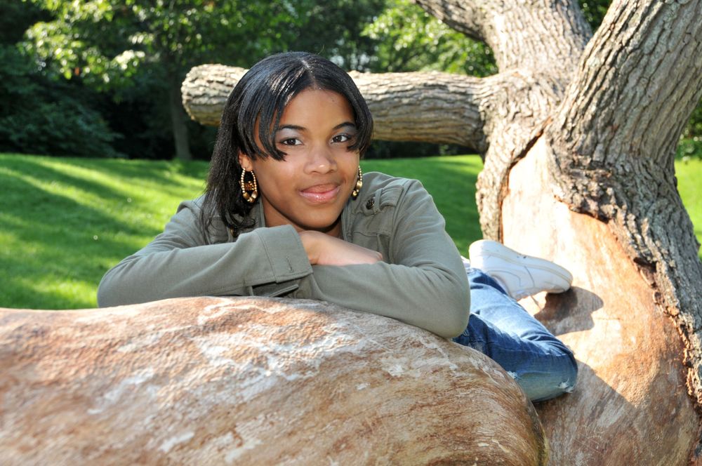 high school senior girl in park on tree