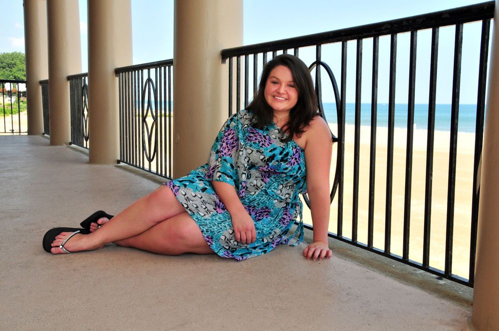 high school senior girl sitting near beach