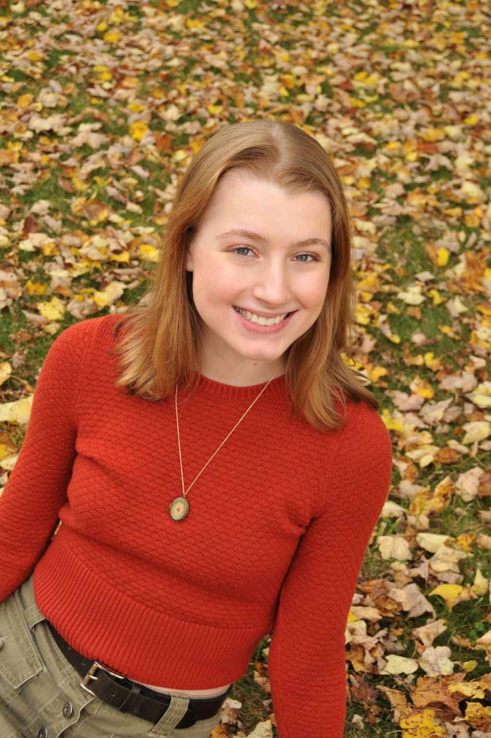 high school senior girl in fall leaves