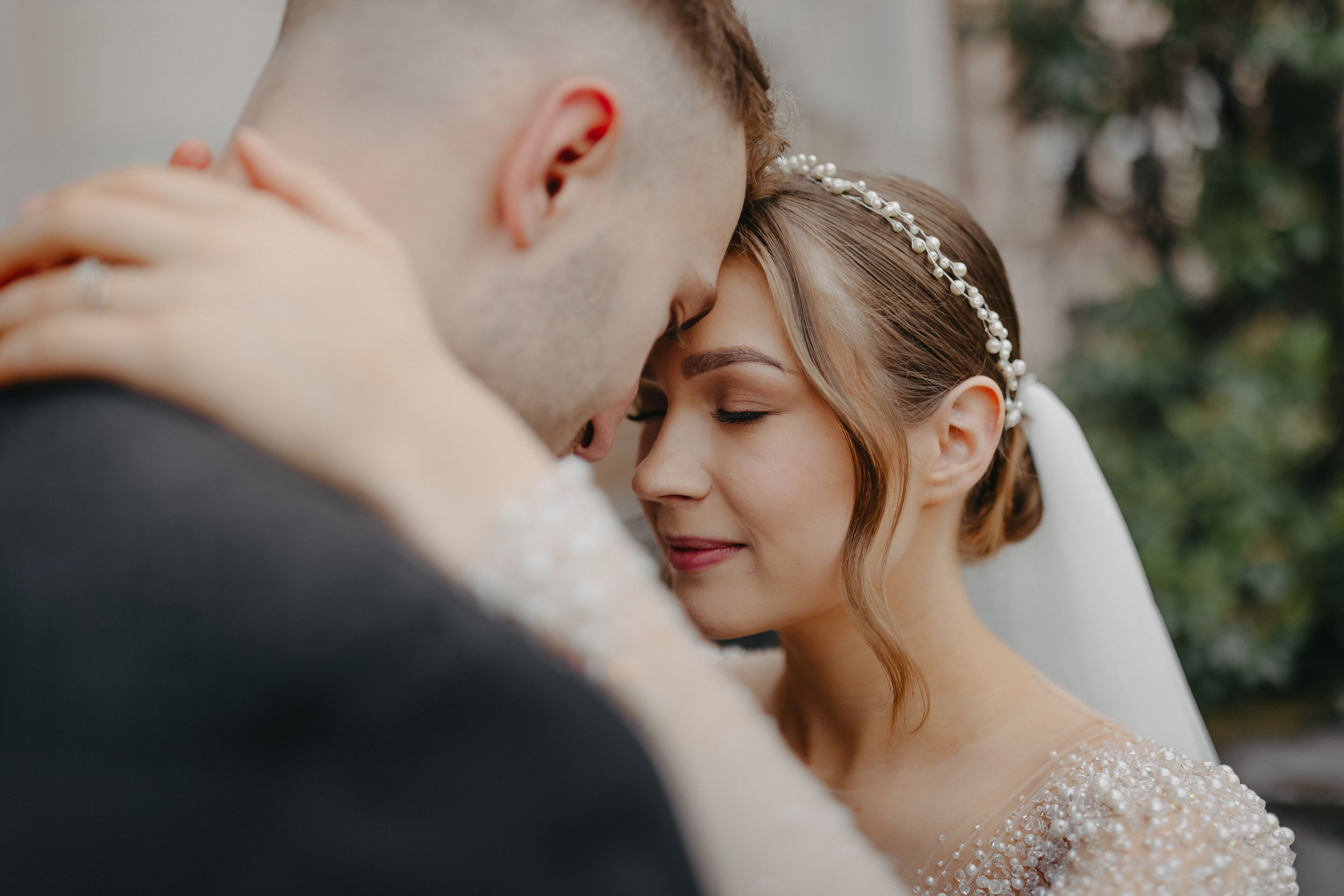 A tender wedding moment shares between newlyweds on their special day.