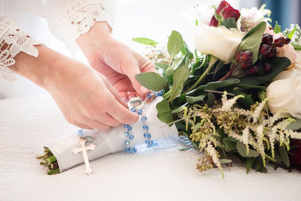 Close-up of hands arranging delicate floral decorations.