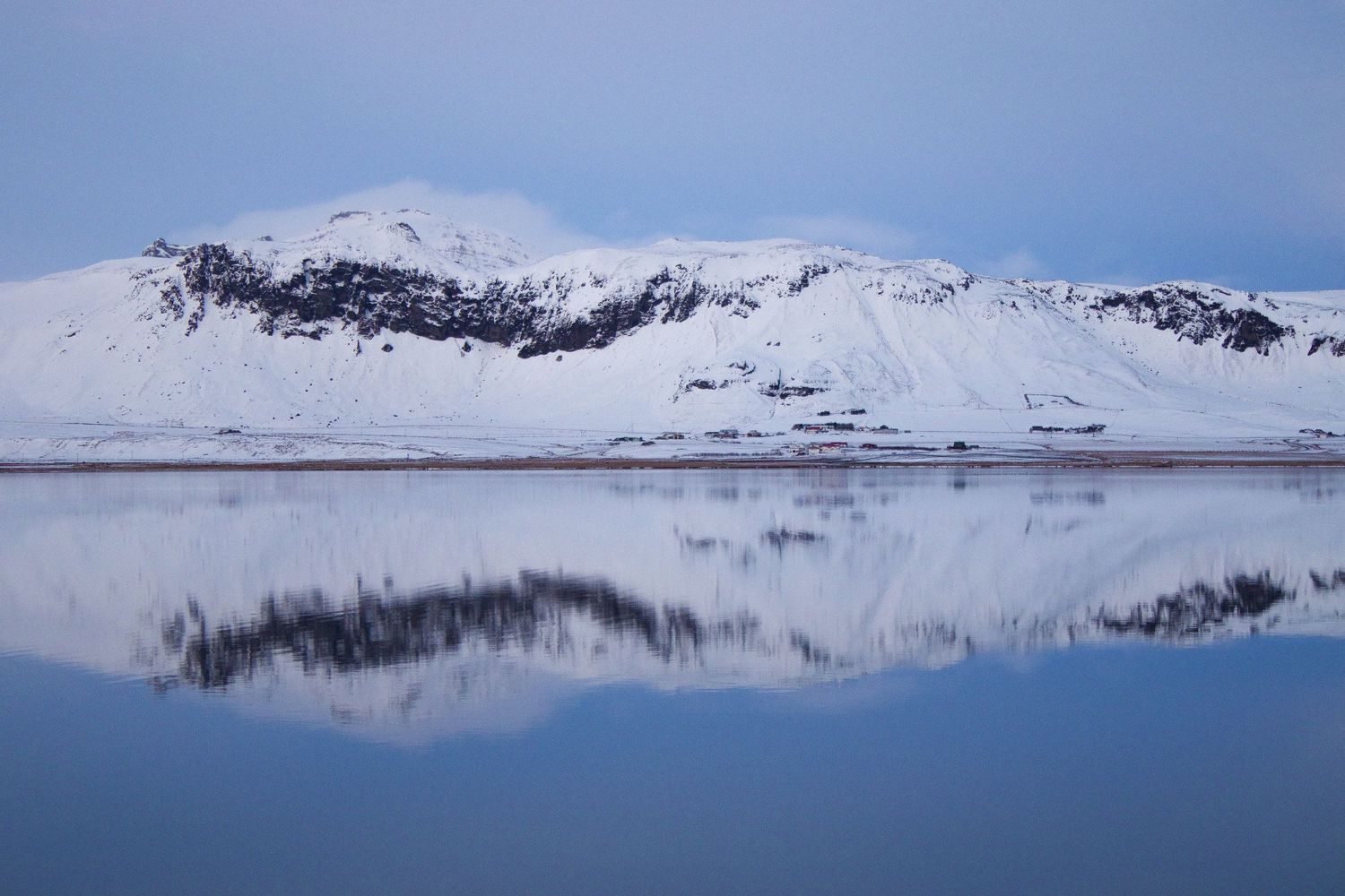 High resolution photograph of the beautiful snow-covered landscape in Iceland with a stunning reflection in the water.