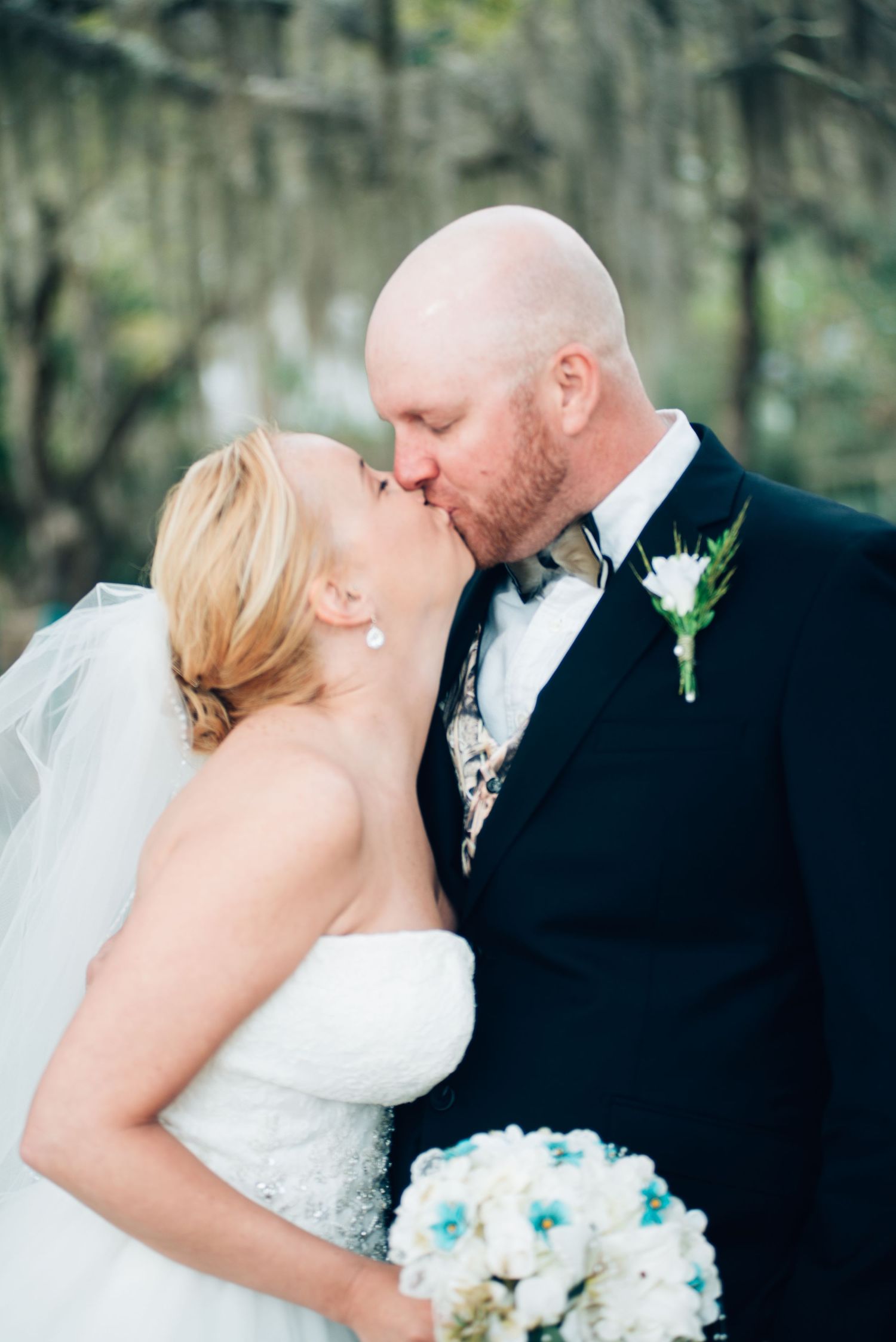 An intimate wedding portrait captured outdoors with soft lighting and natural scenery.