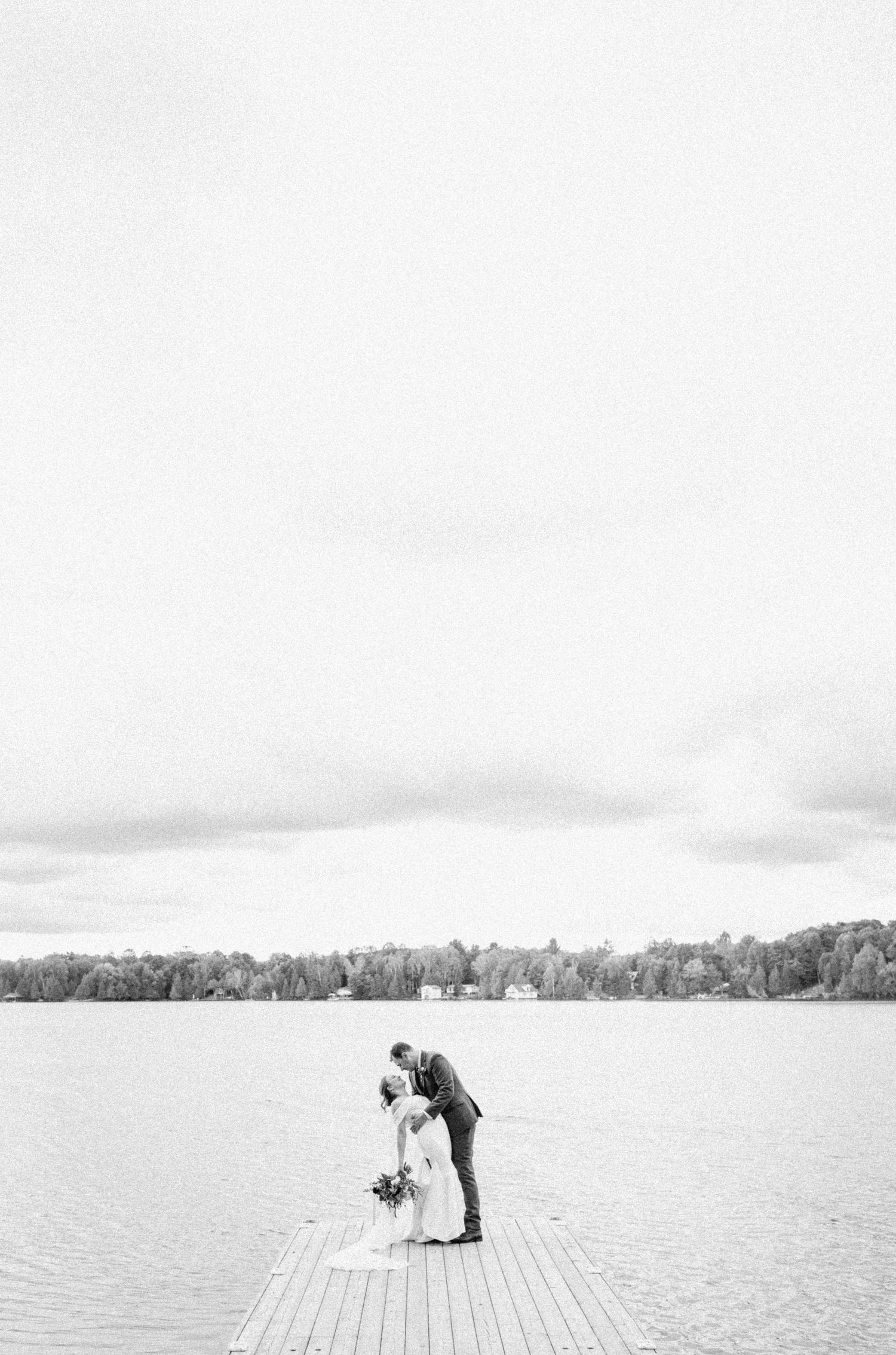 Couples First look on dock in Lake Cecebe-Alexis Anne Photography-Muskoka Wedding Photographer