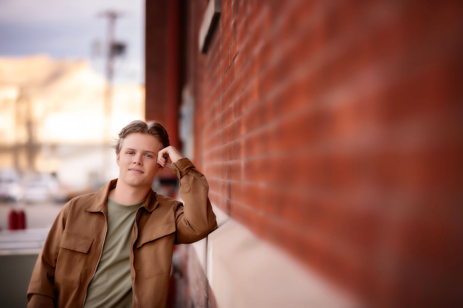 A portrait against a rustic brick wall with shallow depth of field.