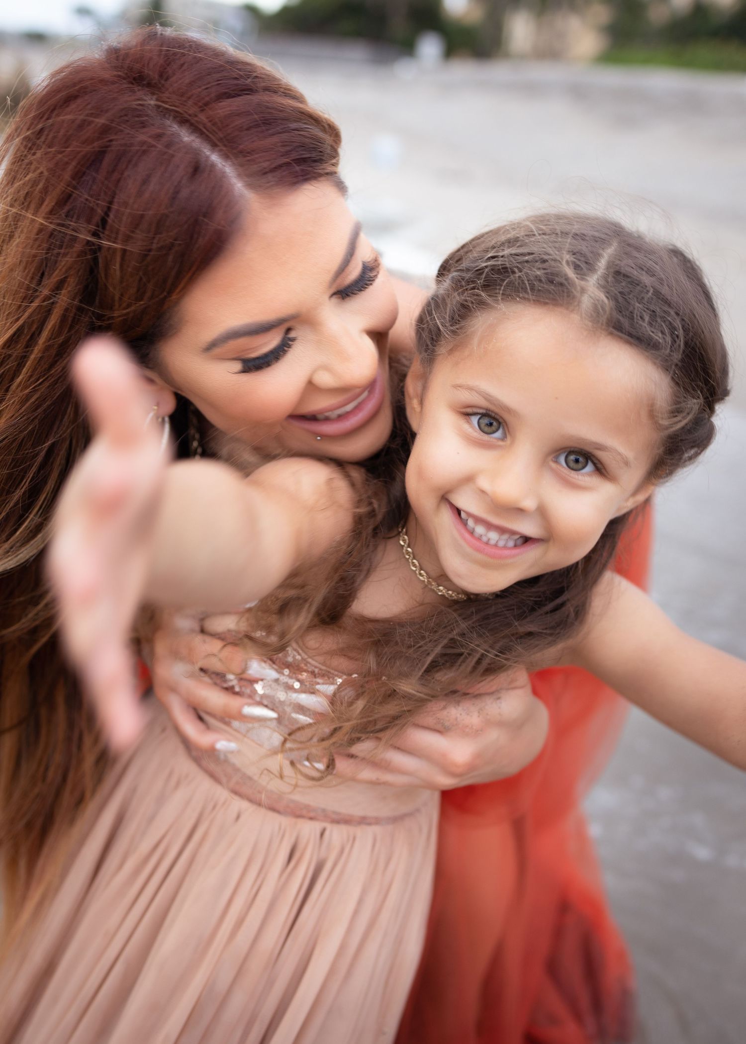 A heartwarming moment between parent and child sharing joyful smiles outdoors.