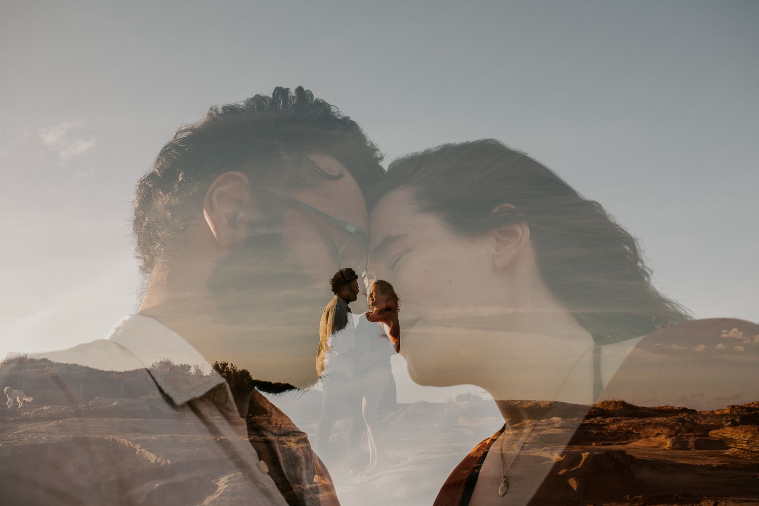 A romantic double exposure photo of a couple kissing, blended with a scenic landscape background.