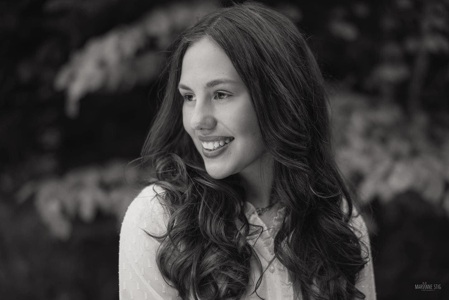 Black and white portrait photo with natural outdoor lighting.