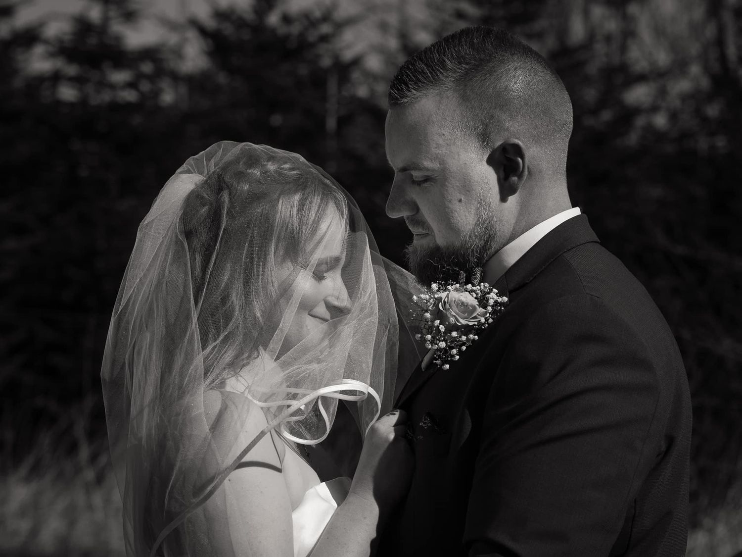 Wedding couple embracing in romantic black and white photo series outdoors.