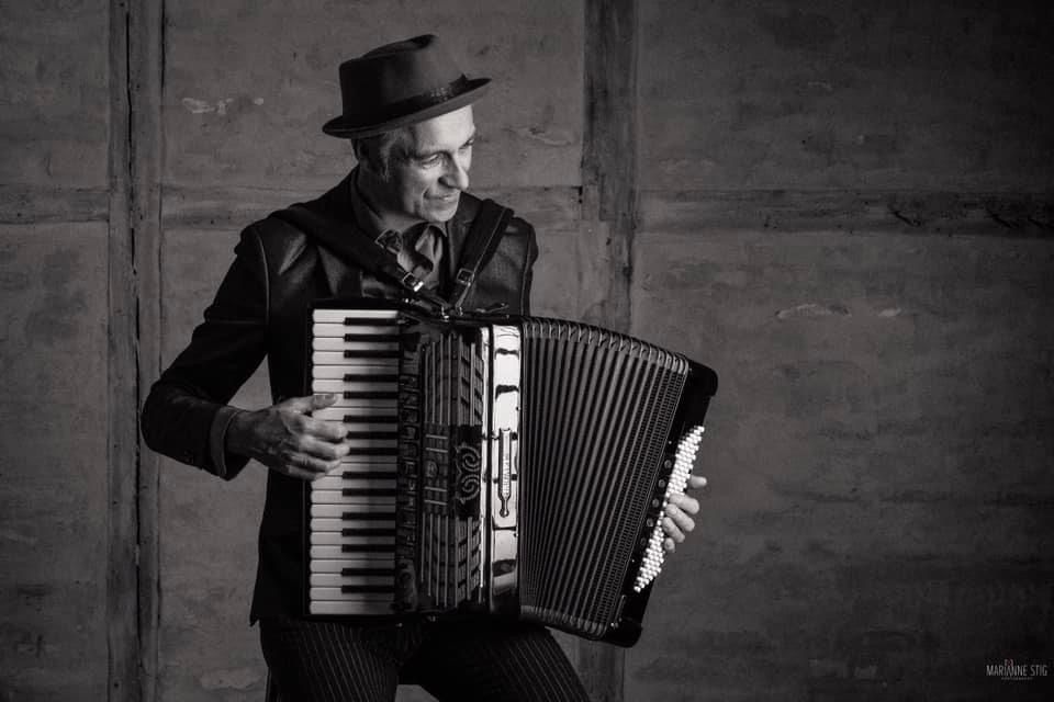 Black and white photo sequence of musician playing accordion against rustic wall background.