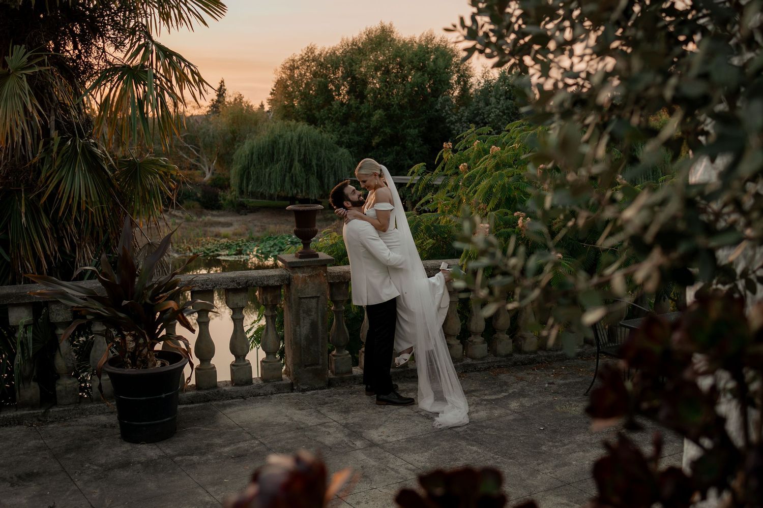 Romantic moment captured at sunset in a garden terrace setting.