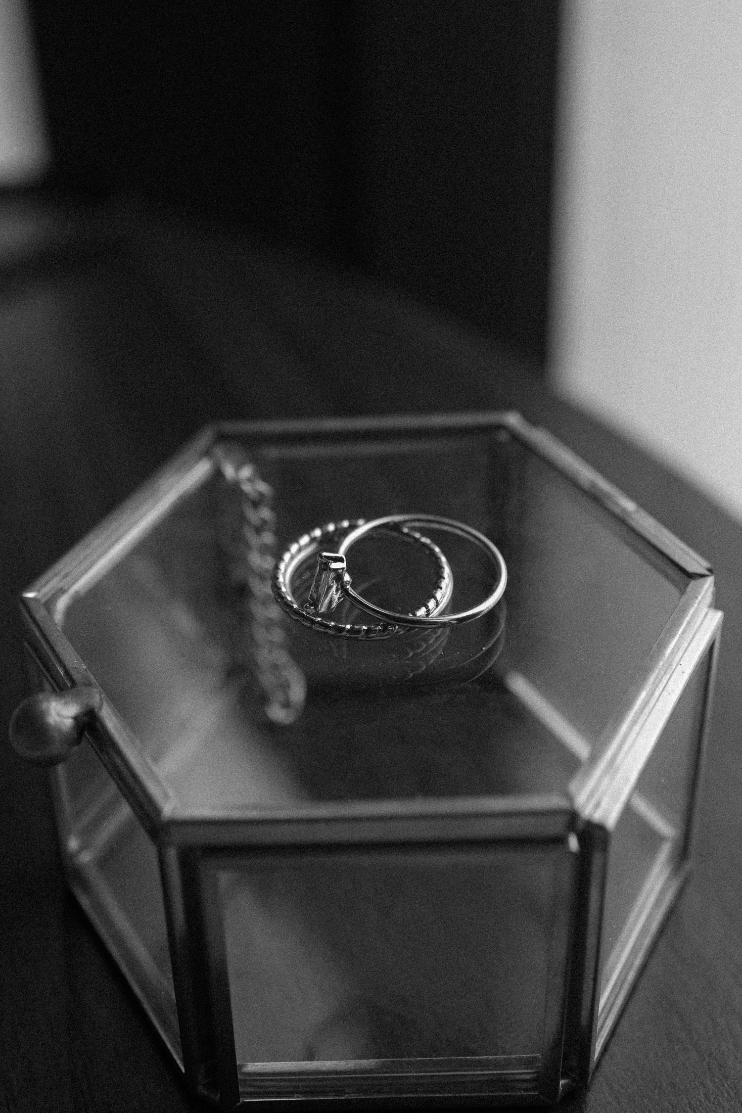 Wedding rings displayed on a modern geometric black hexagonal jewelry box.