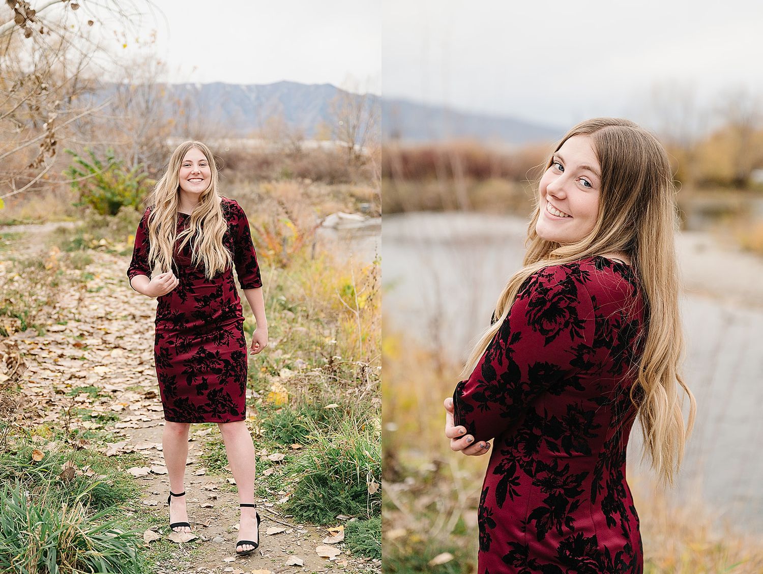 A woman in a burgundy velvet dress poses by a river during autumn with mountains in the background.