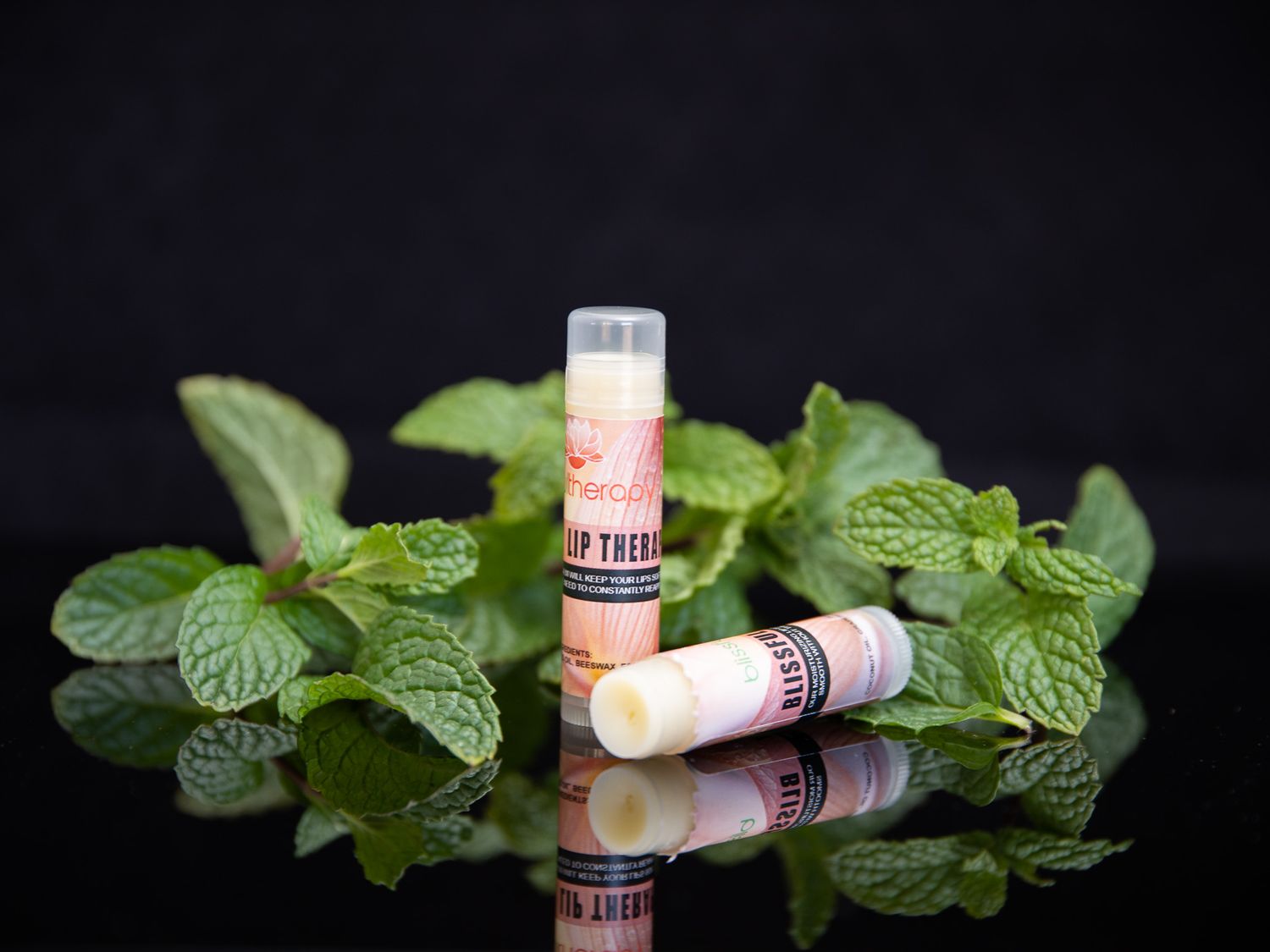 Fresh mint leaves arranged with cork stoppers against dark background.