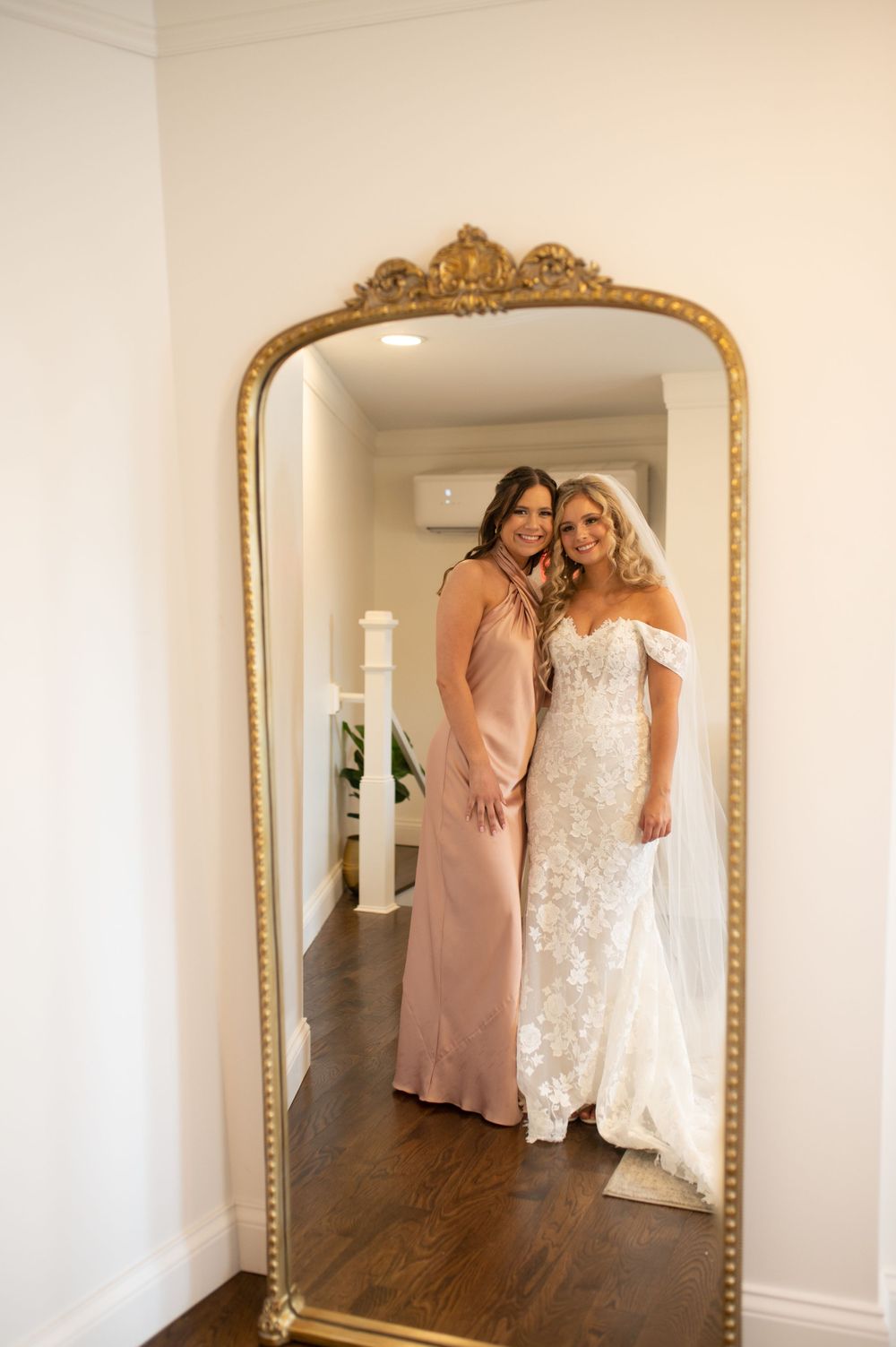 Elegant bridal preparation scene captured in ornate gold-framed mirror.