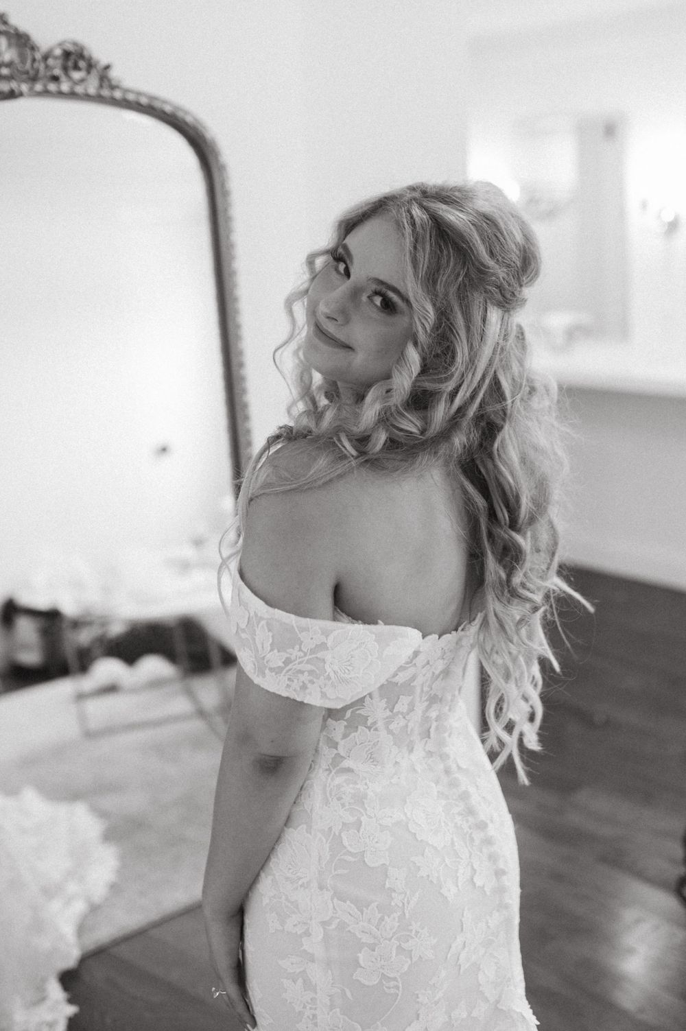 Classic bridal portrait in black and white with ornate vintage mirror.