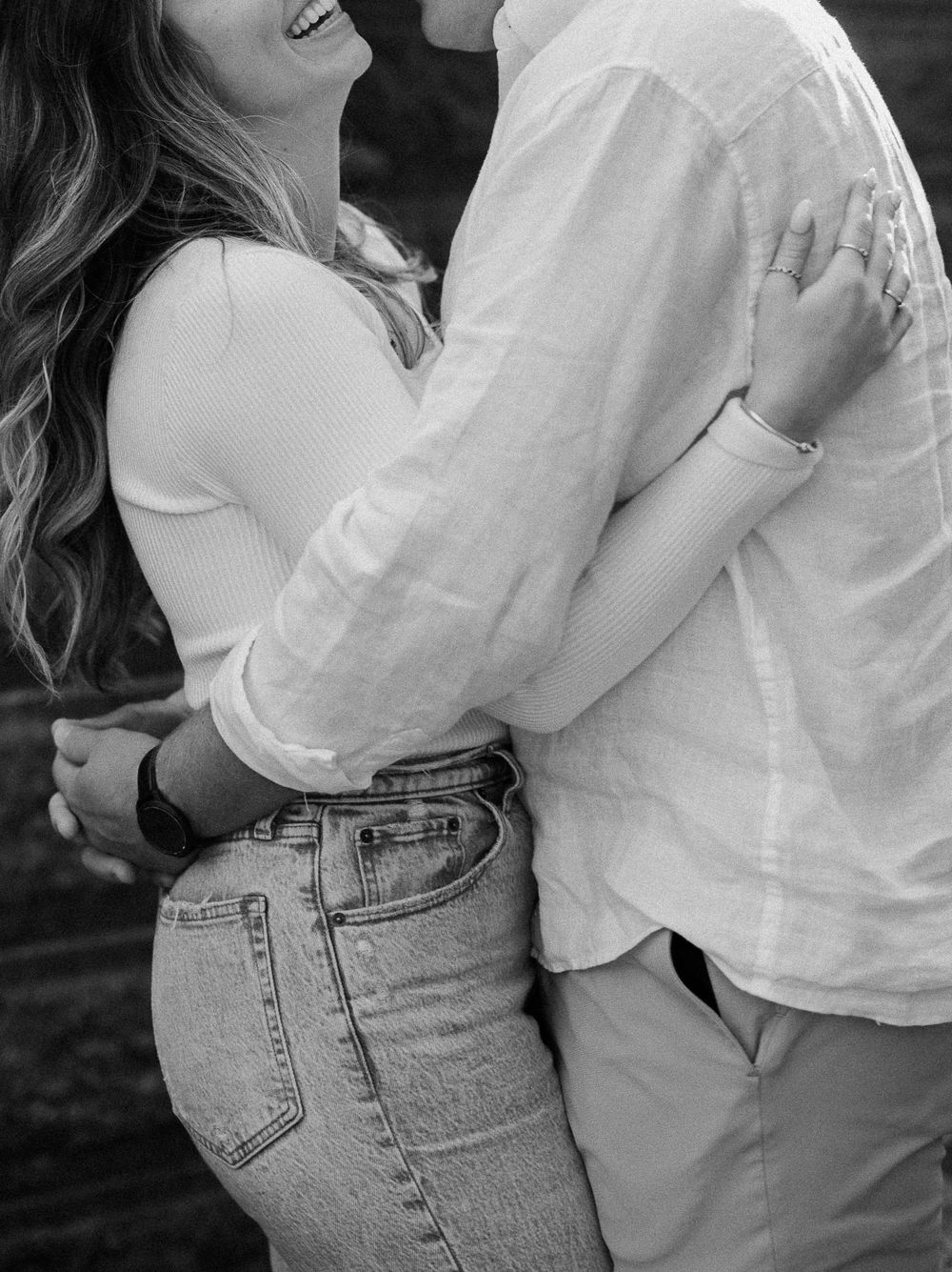 Close-up shots of couple embracing in casual white and denim outfits.