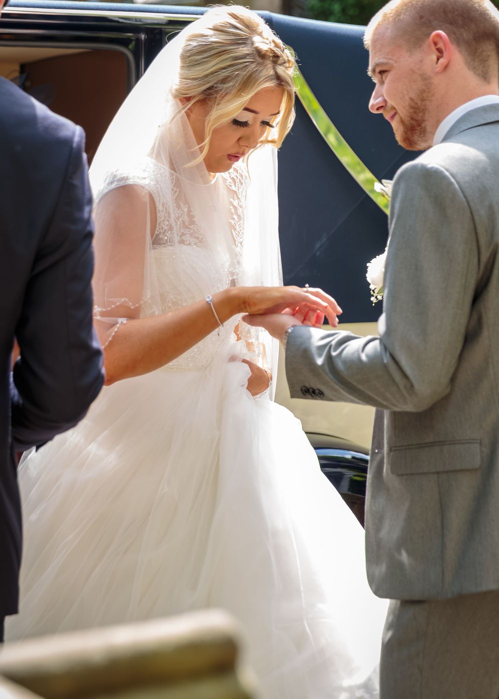 bride helped out of the wedding car at west tower ormskirk