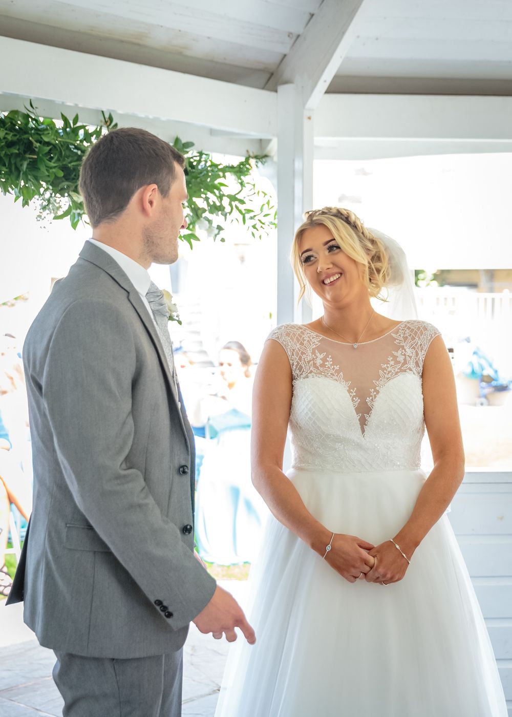 bride smiling at the groom in the gazebo at west tower wedding venue ormskirk