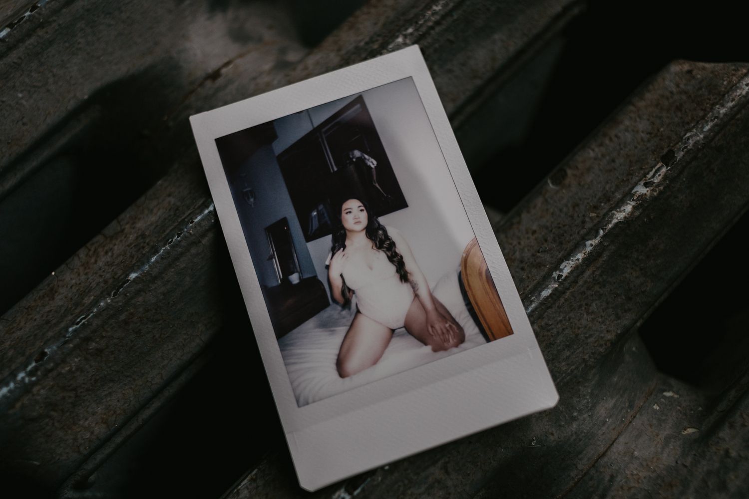 A polaroid sits on an old radiator. Barrie Luxury Boudoir Photographer