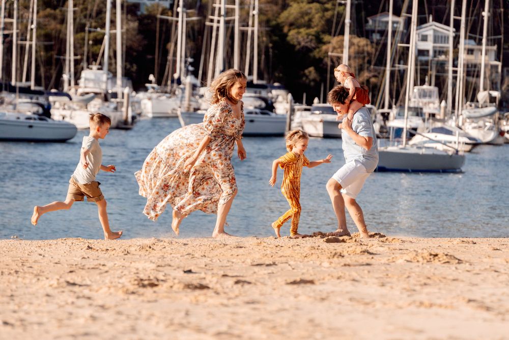 Playing catch at the family photoshoot at the beach in Sydney