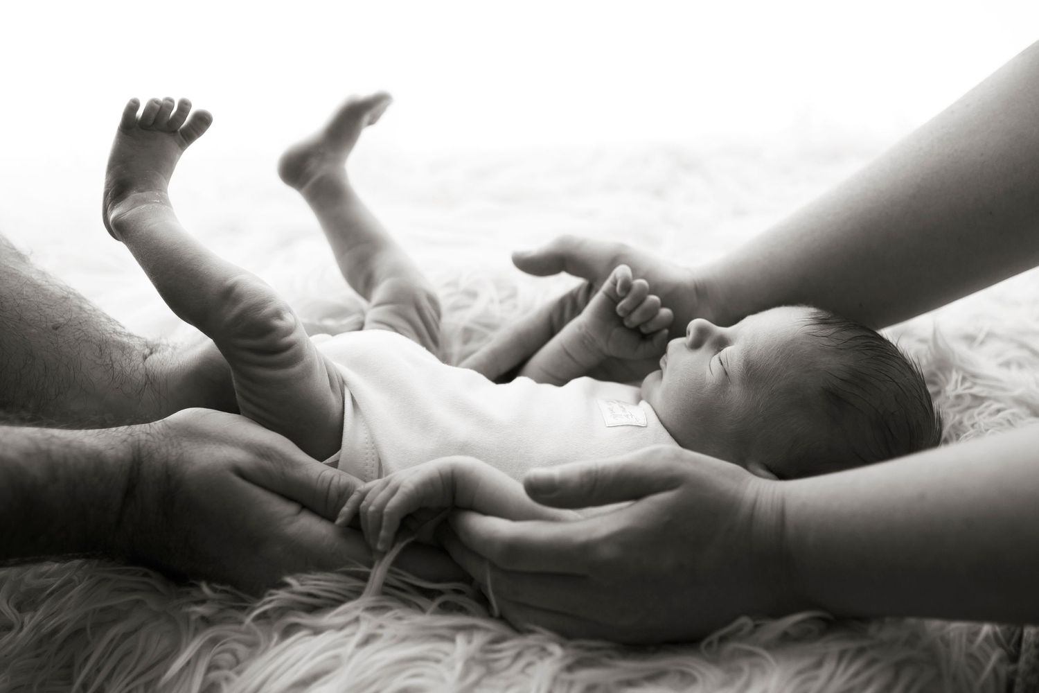 newborn baby and parents hands, photographed at Little Wonderland Photography, Widnes, Cheshire
