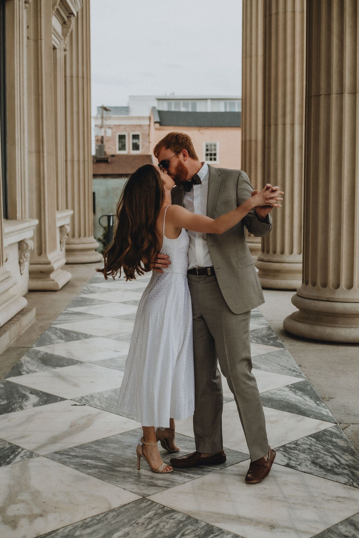 A couple shares a kiss while dancing