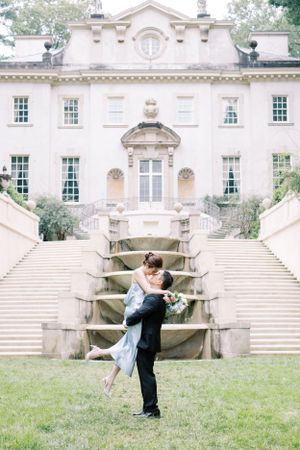 Romantic dance sequence on the lawn of a grand historic mansion with sweeping stone staircases.