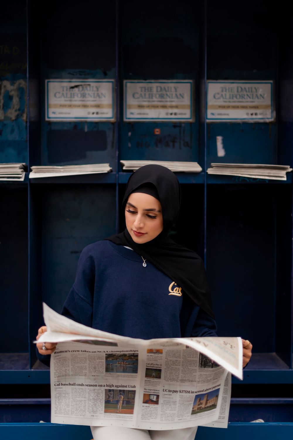 hijabi girl posing in a high school senior portrait taken at UC Berkeley Photographed by Shumesa Mohsin