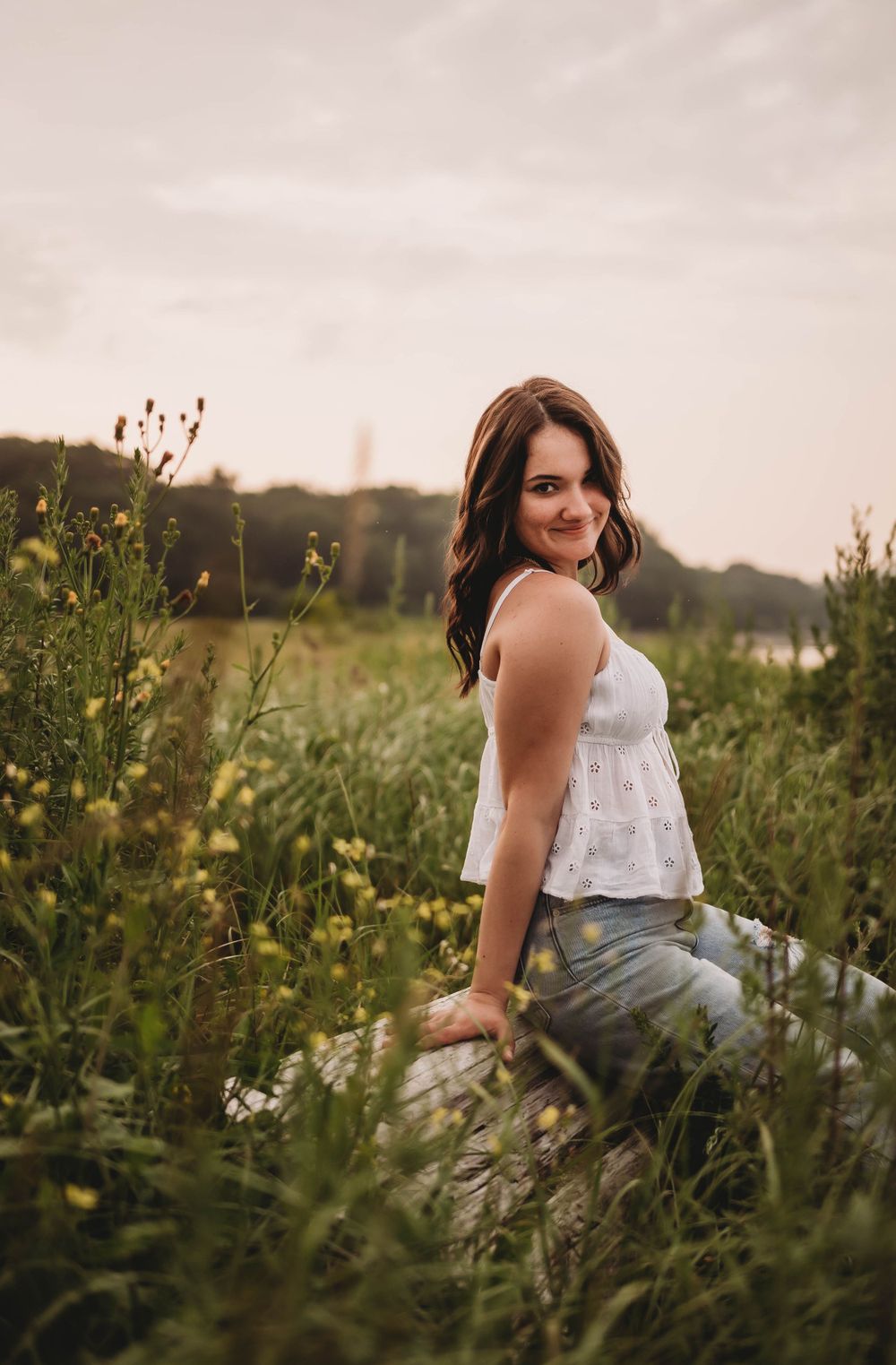 Summer portrait in a field of wildflowers during golden hour.